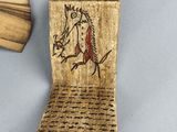 two pieces of wood with a horse on it and a fan in the background