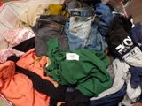 a basket full of clothes that is sitting on the floor
