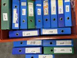 a lot of blue and green binders in a red box