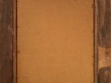 an old wooden frame with a piece of paper taped to it