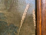 a close up of a painting of a bird on a wall