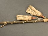 two brooms that are tied together on a stick