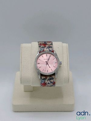 a watch that is on display on a white stand