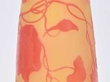a yellow and red vase sitting on a white surface