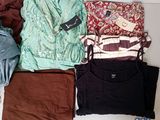 a lot of clothes that are sitting on a table