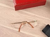 a pair of glasses, a cell phone, and a red box on the floor