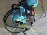 a blue machine with a green hose and a yellow hose
