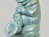 statue of a frog with a hat and a hat on its back