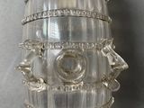 a glass vase with a face on it on a table
