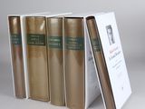 three books are stacked on top of each other on a table