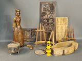 a statue of a woman standing next to a pile of art supplies