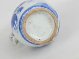 a blue and white vase sitting on a white surface