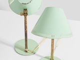 two light green lamps on a white surface with a white background