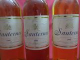 several bottles of wine are lined up in a row on a table