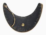 a black leather collar with a gold button on it