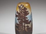 a small vase with a picture of a tree on it
