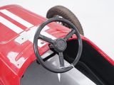 a red toy car with a steering and a steering wheel