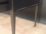 a black desk with a drawer underneath it