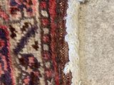 a rug on the floor with a cat laying on it