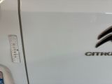 a close up of a white car with a citroen logo on it