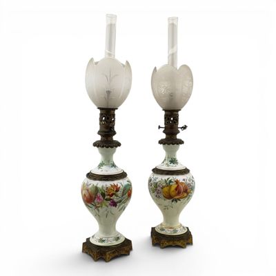 pair of white and green vases with flowers and leaves on them