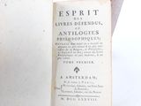 an old book that is open on a table