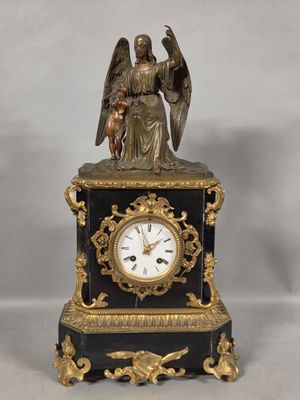a statue of an angel holding a bird on top of a clock