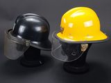 two hard hats and a helmet on a black background