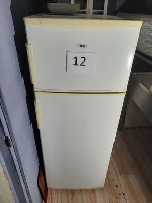 a white refrigerator with a number on it in a kitchen