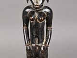 statue of a man with a helmet on his head, standing on a wooden base