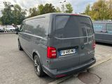 a grey van that is parked in a parking lot