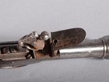a small metal object that looks like a gun