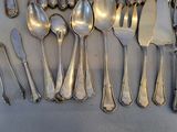a lot of silver spoons and spoon spoons on the table