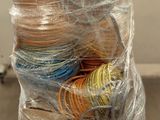 a pile of yarn wrapped in plastic on top of a pallet