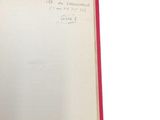 an open book with writing on it on a white surface