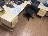 a desk with a chair and a computer on it