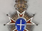 an image of a medal with a cross on it and a ribbon around it