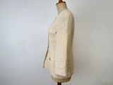 beige jacket on a mannequin stand against a white wall