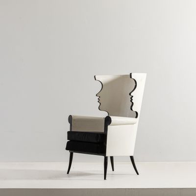 a black and white chair with a mirror on the back of it