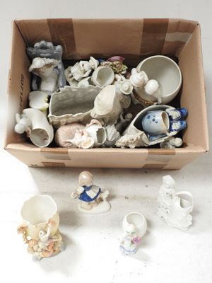 une boîte en carton remplie de petites figurines en céramique posée sur une table