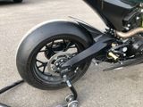 a close up of a motorcycle parked in a parking lot