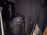 many chairs in a room with a black curtain