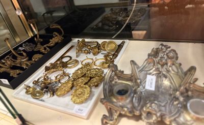 a display case with a lot of gold jewelry on it