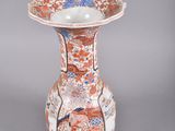 a vase with a floral design on it sitting on a table