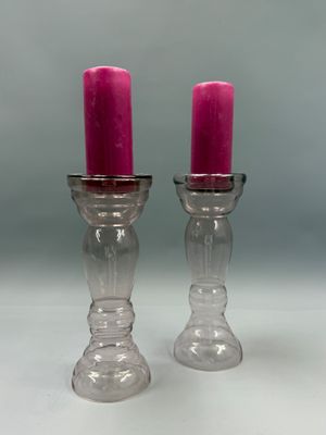 deux bougies roses posées sur une table