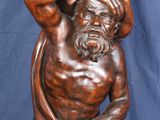 an image of a statue of a man holding a pot on his head