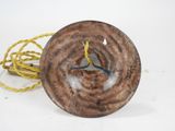 a brown object with a yellow cord on a white surface