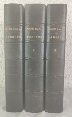 three books are lined up in a row on a table