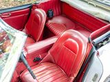 an image of a red and white car with red leather seats