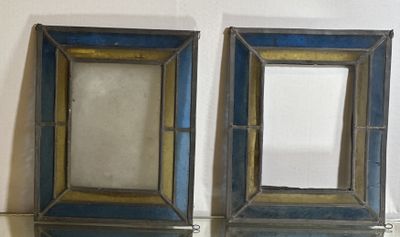two mirrors that are on the wall next to each other